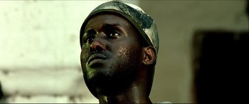 Movie still from “Black Hawk Down” (2001), directed by Ridley Scott – A person wearing a hat; Close Up shot, Low angle