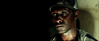 Movie still from “Black Hawk Down” (2001), directed by Ridley Scott – A person wearing a hat; Close Up shot, Low angle