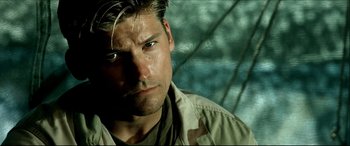 Movie still from “Black Hawk Down” (2001), directed by Ridley Scott – A person wearing a camouflage shirt; Close Up shot, Over the shoulder angle