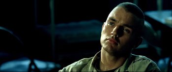 Movie still from “Black Hawk Down” (2001), directed by Ridley Scott – A person wearing a shirt; Close Up shot, Low angle