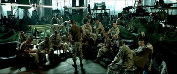 Movie still from “Black Hawk Down” (2001), directed by Ridley Scott – A group of men sitting on top of each other; Wide shot, High angle