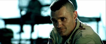 Movie still from “Black Hawk Down” (2001), directed by Ridley Scott – A person wearing a military uniform; Close Up shot, Low angle