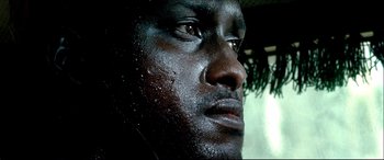 Movie still from “Black Hawk Down” (2001), directed by Ridley Scott – A man's face covered in rain drops; Extreme Close Up shot, Low angle