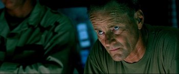 Movie still from “Black Hawk Down” (2001), directed by Ridley Scott – A person looking at the camera; Close Up shot, Low angle