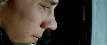 Movie still from “Black Hawk Down” (2001), directed by Ridley Scott – A man's face with a lot of dirt on his face; Extreme Close Up shot, Low angle