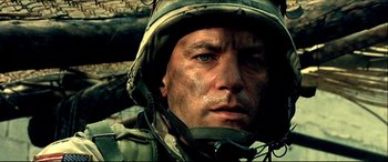 Movie still from “Black Hawk Down” (2001), directed by Ridley Scott – A person wearing a helmet; Close Up shot, Low angle