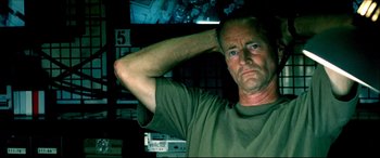 Movie still from “Black Hawk Down” (2001), directed by Ridley Scott – A person holding his hand up to his head; Close Up shot, Low angle