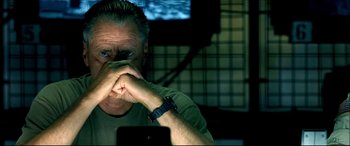 Movie still from “Black Hawk Down” (2001), directed by Ridley Scott – A person holding his hands to his face; Close Up shot, Over the shoulder angle