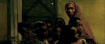 Movie still from “Black Hawk Down” (2001), directed by Ridley Scott – A group of people standing next to each other in the dark; Medium shot, Low angle