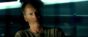 Movie still from “Black Hawk Down” (2001), directed by Ridley Scott – An older man is looking at the camera; Close Up shot, Low angle