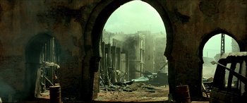 Movie still from “Black Hawk Down” (2001), directed by Ridley Scott – An arched doorway in an abandoned city; Extreme Wide shot, Low angle
