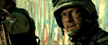 Movie still from “Black Hawk Down” (2001), directed by Ridley Scott – A person wearing a helmet; Close Up shot, High angle