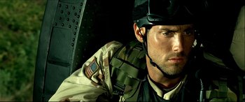 Movie still from “Black Hawk Down” (2001), directed by Ridley Scott – A man wearing a helmet and a camouflage uniform; Close Up shot, Low angle