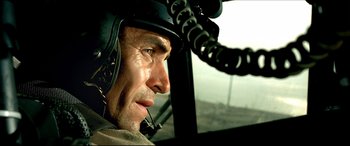 Movie still from “Black Hawk Down” (2001), directed by Ridley Scott – A person in a helicopter; Close Up shot, Low angle