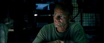 Movie still from “Black Hawk Down” (2001), directed by Ridley Scott – A person sitting in front of a tv; Close Up shot, Over the shoulder angle