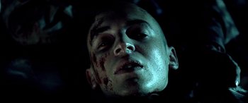 Movie still from “Black Hawk Down” (2001), directed by Ridley Scott – A person's face covered in blood; Close Up shot, Overhead angle