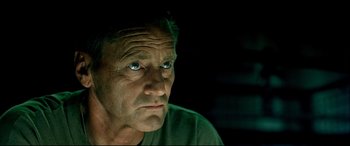 Movie still from “Black Hawk Down” (2001), directed by Ridley Scott – An older man with blue eyes stares into the camera; Close Up shot, Low angle