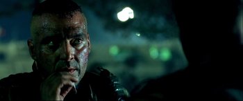 Movie still from “Black Hawk Down” (2001), directed by Ridley Scott – A person wearing a helmet; Close Up shot, Over the shoulder angle