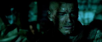 Movie still from “Black Hawk Down” (2001), directed by Ridley Scott – A person with blood all over his face; Close Up shot, Over the shoulder angle