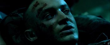Movie still from “Black Hawk Down” (2001), directed by Ridley Scott – A man's face covered in blood; Close Up shot, High angle