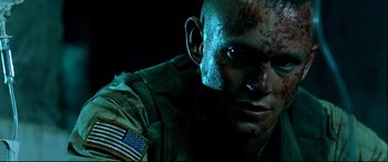 Movie still from “Black Hawk Down” (2001), directed by Ridley Scott – A person with a flag on his face; Close Up shot, Low angle