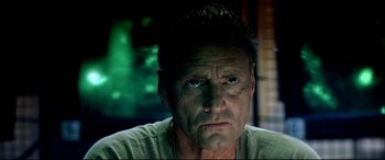 Movie still from “Black Hawk Down” (2001), directed by Ridley Scott – A person wearing a green shirt; Close Up shot, Low angle