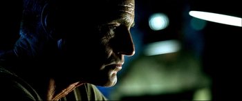 Movie still from “Black Hawk Down” (2001), directed by Ridley Scott – A man's face in the dark; Close Up shot, Low angle