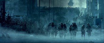Movie still from “Black Hawk Down” (2001), directed by Ridley Scott – A group of soldiers walking across a field; Extreme Wide shot, Low angle