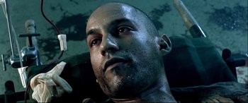 Movie still from “Black Hawk Down” (2001), directed by Ridley Scott – A man's face with dirt all over his face; Close Up shot, Overhead angle