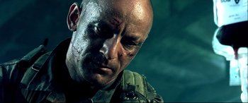 Movie still from “Black Hawk Down” (2001), directed by Ridley Scott – A person with a face covered in blood; Close Up shot, Low angle