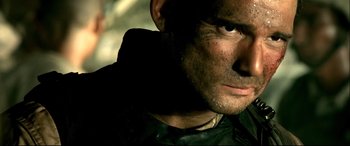 Movie still from “Black Hawk Down” (2001), directed by Ridley Scott – A man's face with dirt on his face; Close Up shot, Over the shoulder angle