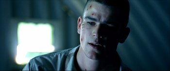 Movie still from “Black Hawk Down” (2001), directed by Ridley Scott – A person with a bruise on his face; Close Up shot, Over the shoulder angle