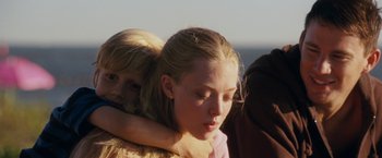 Movie still from “Dear John” (2010), directed by Lasse Hallström – A girl with her arm wrapped around another girl; Close Up shot, Over the shoulder angle