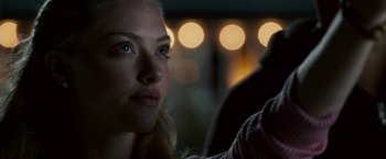 Movie still from “Dear John” (2010), directed by Lasse Hallström – A woman's face in front of lights; Close Up shot, Over the shoulder angle