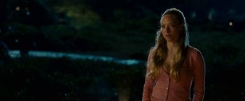 Movie still from “Dear John” (2010), directed by Lasse Hallström – A woman standing in the dark wearing a pink sweater; Medium shot, Over the shoulder angle