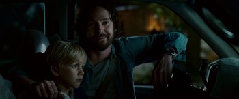 Movie still from “Dear John” (2010), directed by Lasse Hallström – A man and a boy in the back seat of a car; Close Up shot, Over the shoulder angle