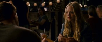 Movie still from “Dear John” (2010), directed by Lasse Hallström – A woman sitting at a table holding a drink; Close Up shot, Over the shoulder angle