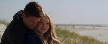 Movie still from “Dear John” (2010), directed by Lasse Hallström – A man and a woman embracing each other on the beach; Close Up shot, Over the shoulder angle