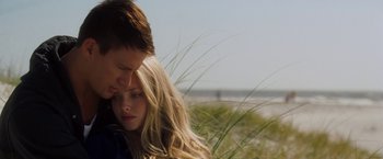 Movie still from “Dear John” (2010), directed by Lasse Hallström – A man and a woman embracing each other on the beach; Close Up shot, Over the shoulder angle