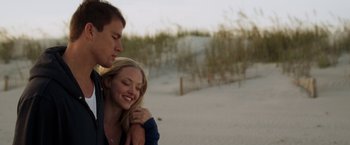 Movie still from “Dear John” (2010), directed by Lasse Hallström – A man and a woman hugging on the beach; Medium shot, Low angle