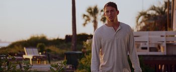 Movie still from “Dear John” (2010), directed by Lasse Hallström – A man standing in the grass near a palm tree; Medium shot, Over the shoulder angle