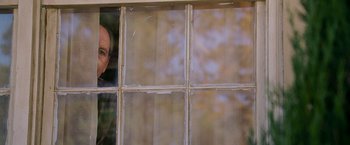 Movie still from “Dear John” (2010), directed by Lasse Hallström – An older man looking out of a broken window; Medium shot, Over the shoulder angle