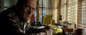 Movie still from “Dear John” (2010), directed by Lasse Hallström – An older man sitting at a dining room table; Close Up shot, Over the shoulder angle