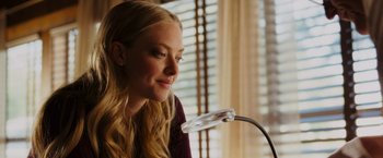 Movie still from “Dear John” (2010), directed by Lasse Hallström – A beautiful blonde woman looking at a magnifying glass; Close Up shot, Over the shoulder angle