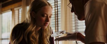 Movie still from “Dear John” (2010), directed by Lasse Hallström – A woman looking at a magnifying glass with a man holding it; Close Up shot, Over the shoulder angle