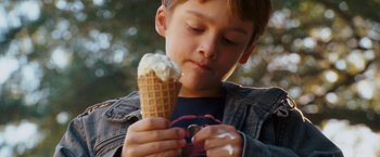 Movie still from “Dear John” (2010), directed by Lasse Hallström – A young boy holding an ice cream cone in his hands; Close Up shot, Overhead angle