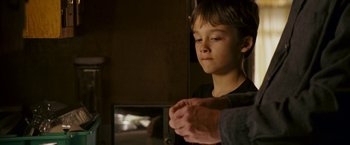 Movie still from “Dear John” (2010), directed by Lasse Hallström – A young boy holding his hands with an older man; Close Up shot, Over the shoulder angle