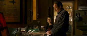 Movie still from “Dear John” (2010), directed by Lasse Hallström – A man and a boy washing dishes in a kitchen; Medium shot, Over the shoulder angle