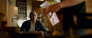 Movie still from “Dear John” (2010), directed by Lasse Hallström – An older man sitting at a table in front of a person; Medium shot, Over the shoulder angle