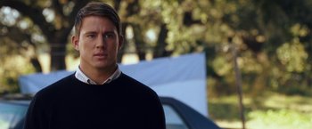 Movie still from “Dear John” (2010), directed by Lasse Hallström – A young man standing in front of a blue car; Close Up shot, Over the shoulder angle